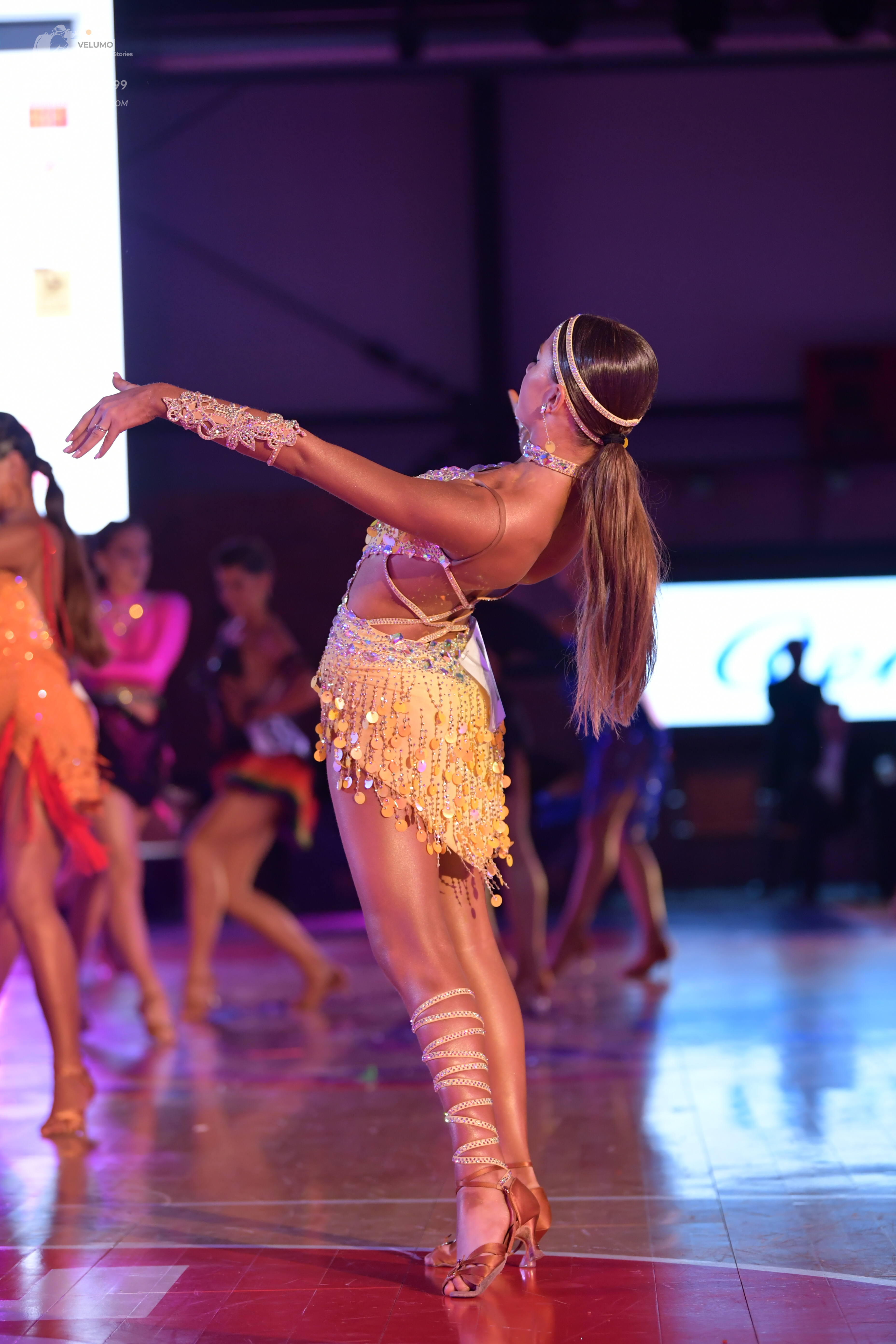 Dancesport competitor: Main dancer: light gold Latin costume with sequins and long gold fringe, a match