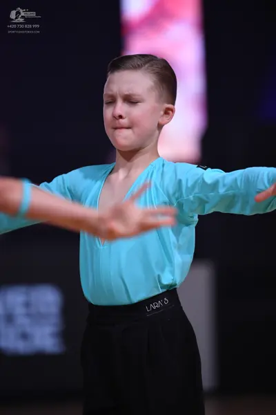 Dancesport competitor: Male dancer: light blue long-sleeved shirt and black trousers