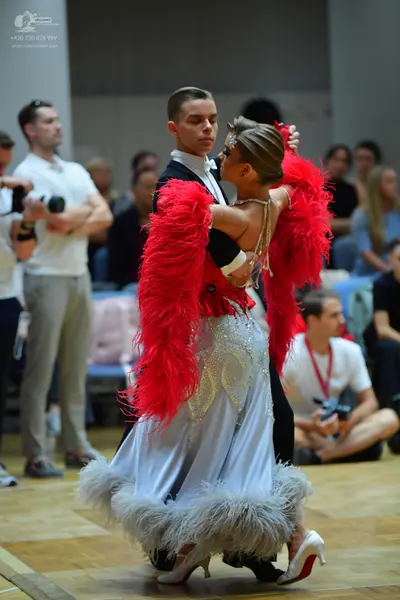 Dancesport competitor: Male dancer: black ballroom suit with a white shirt and white bow tie