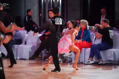 Dancesport competitor #601: Male dancer: black long-sleeved top with silver sequins on the shoulder and blac