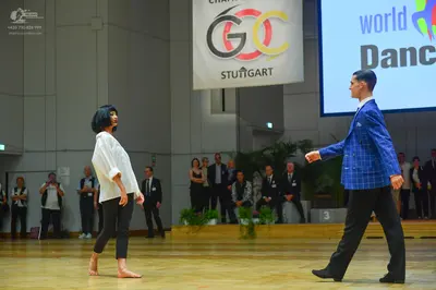 Dancesport competitor: Male dancer: blue patterned suit jacket and black trousers