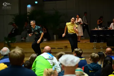 Dancesport competitor: Male dancer: short-sleeved dark patterned shirt and black trousers