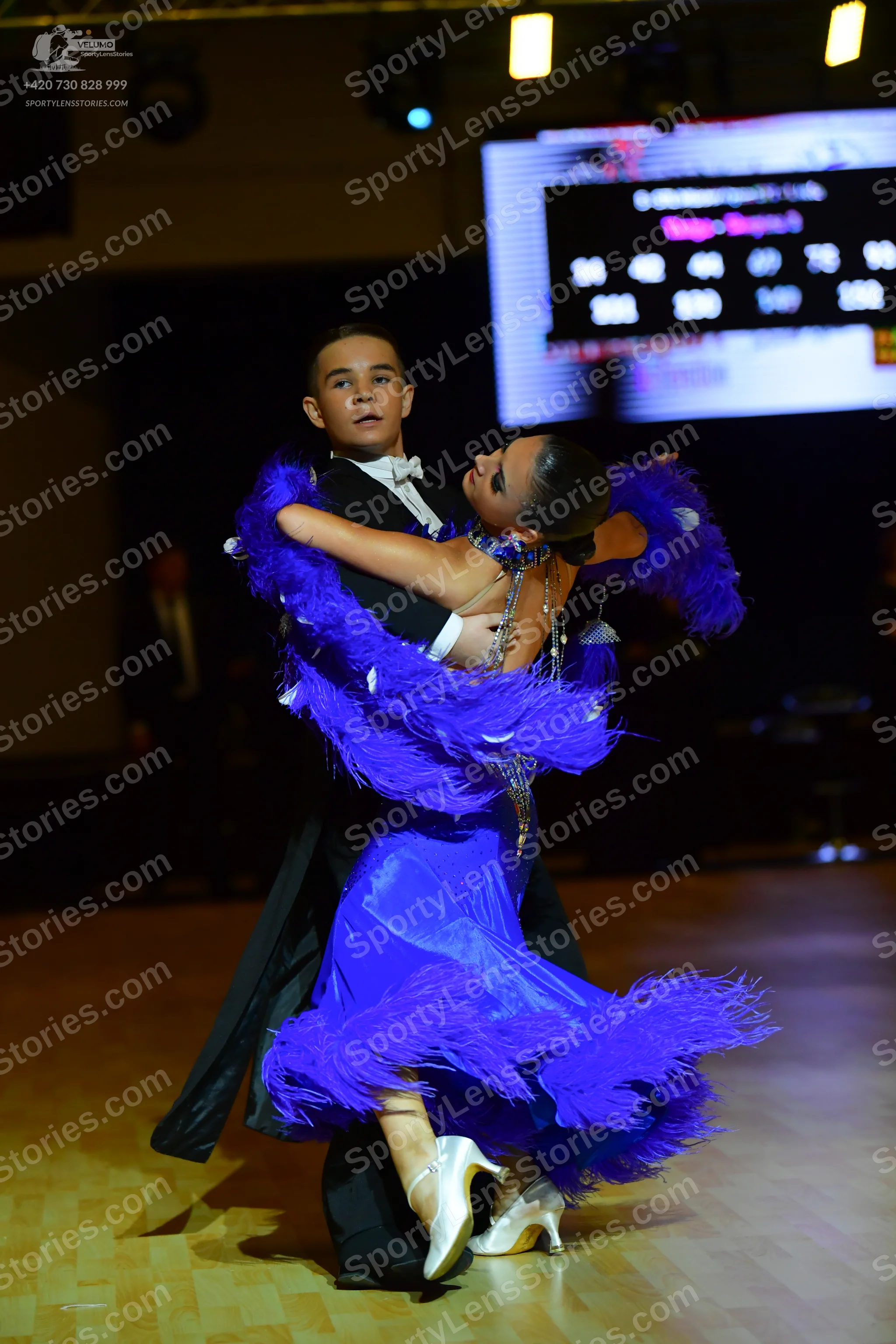 Dancesport competitor: Male dancer: black suit with a white shirt and white bowtie