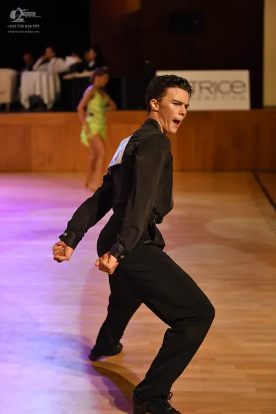 Dancesport competitor: Male dancer: black long-sleeve shirt and black trousers