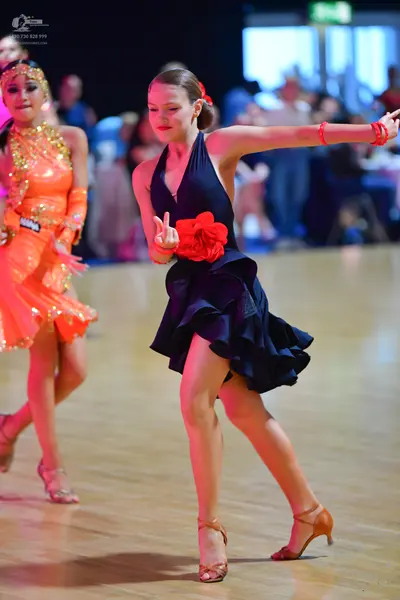 Dancesport competitor: Female dancer 1: orange/gold sequined latin dress with a matching sleeve