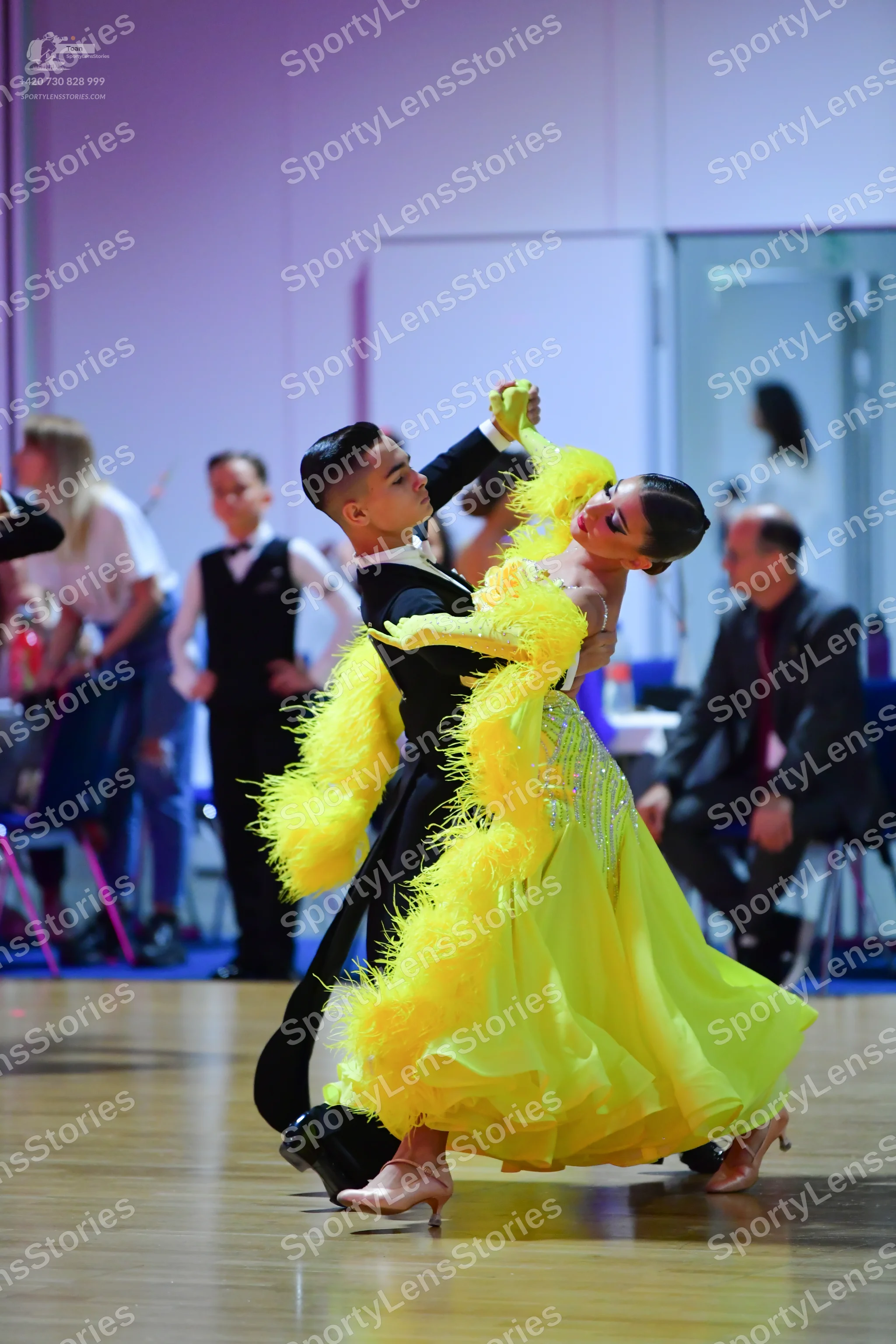 Dancesport competitor: Male dancer: black long-sleeved ballroom top with white trim and black trousers
