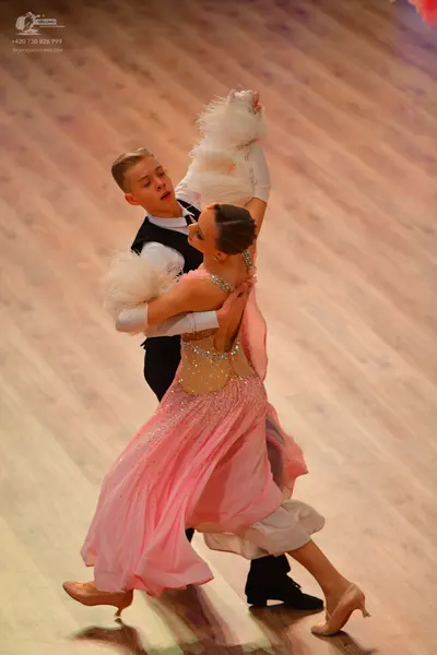 Dancesport competitor: Male dancer: black waistcoat over a white long-sleeved shirt and black trousers