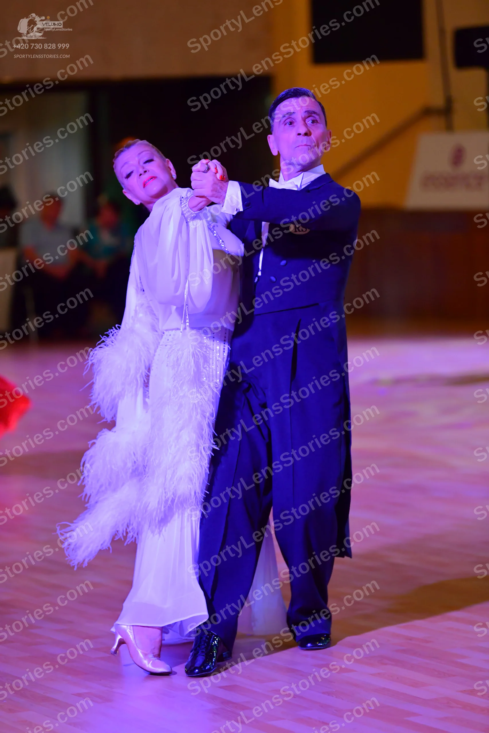 Dancesport competitor: Male dancer: black ballroom suit with a white shirt and dark waistcoat