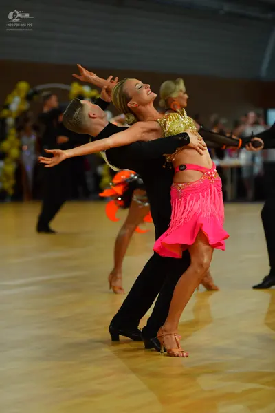 Dancesport competitor: Male dancer: black suit, black trousers, and black dance shoes