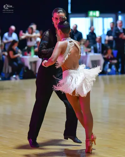 Dancesport competitor: Male dancer: black long-sleeved shirt and black trousers