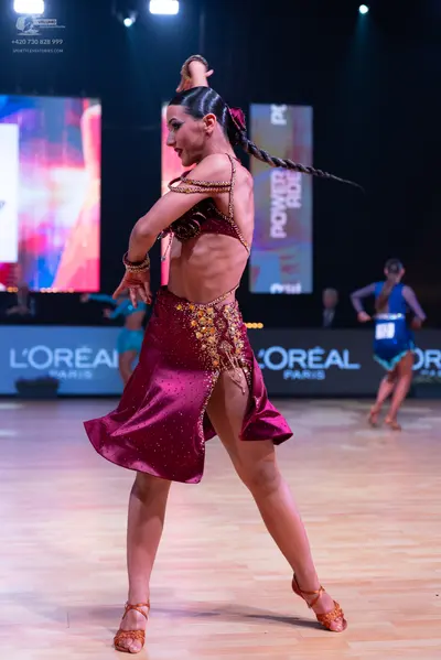 Dancesport competitor: Main female dancer: burgundy satin latin dress with gold sequin and embroidery d