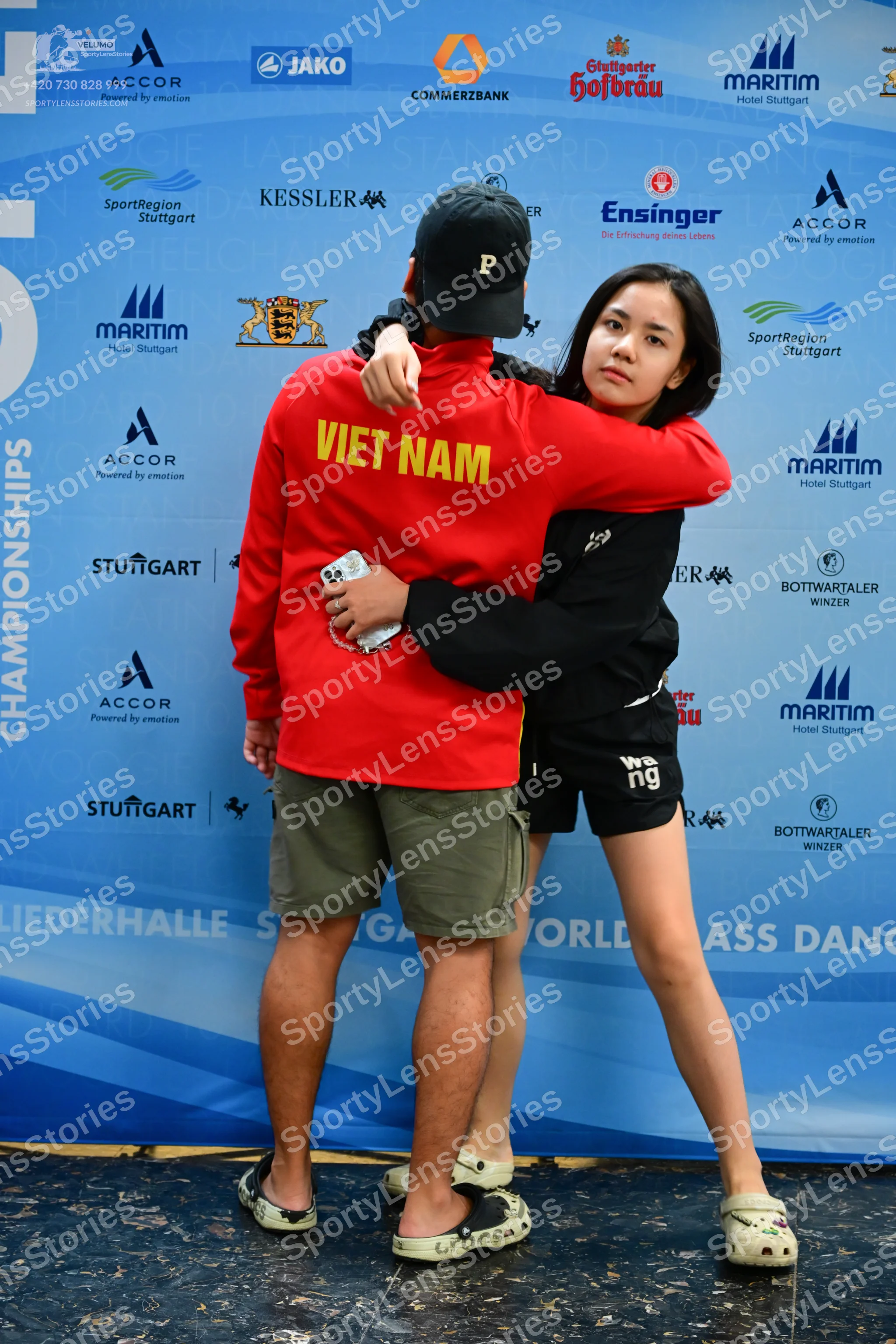Dancesport competitor: Male dancer: red long-sleeved sweatshirt with "VIET NAM" in yellow on the back,