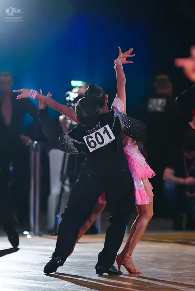 Dancesport competitor #601: Male dancer: black long-sleeved top with sequins on the upper back/shoulders and