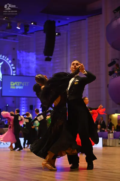 Dancesport competitor: Male dancer: black suit and white shirt