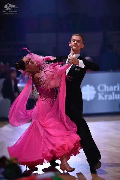 Dancesport competitor: Male dancer: black suit with a white shirt and black bowtie