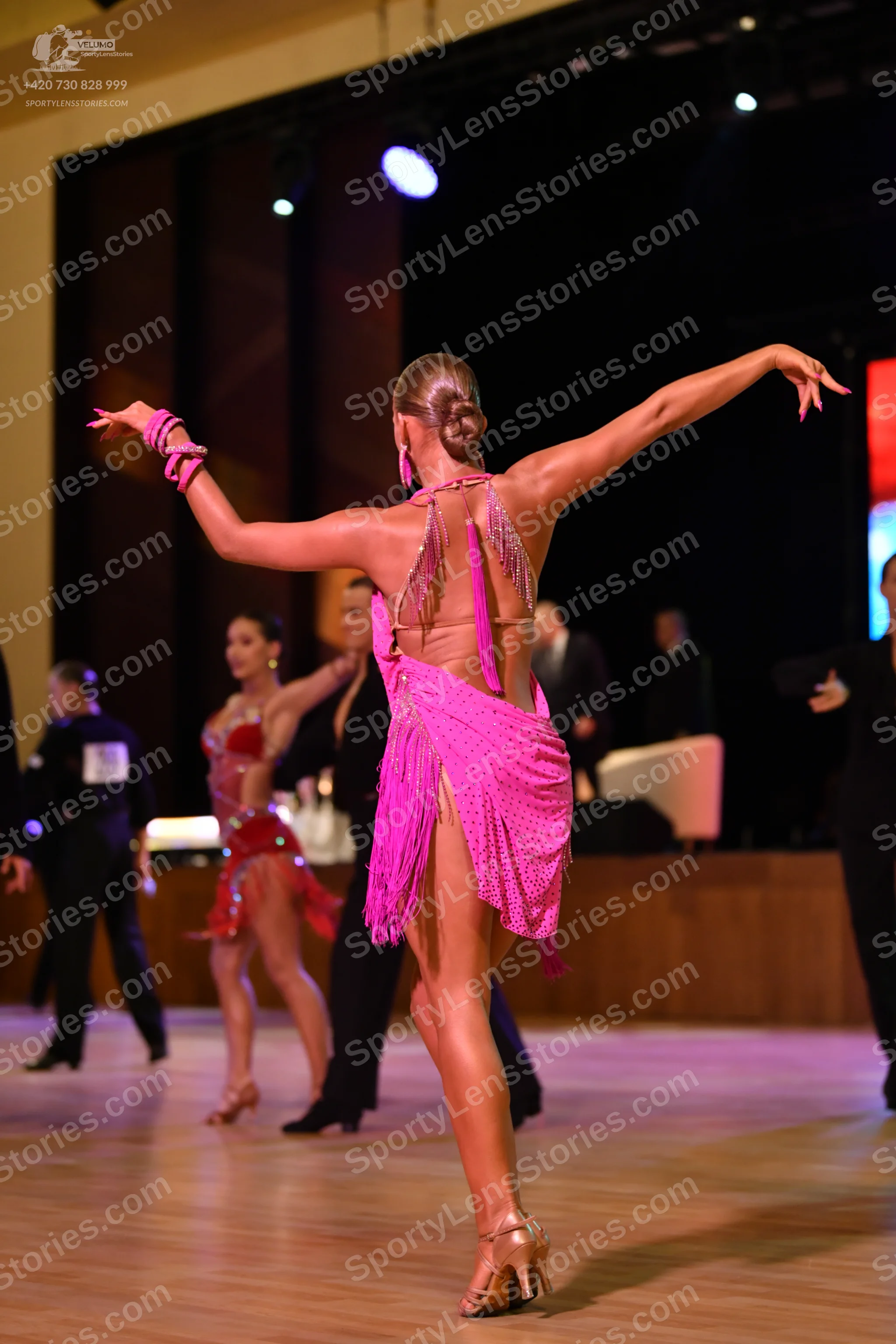 Dancesport competitor: ** Pink Latin dress
*   **Color:** Vibrant pink
*   **Fabric:** Appears to be a 