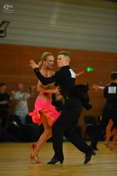 Dancesport competitor: ** Red Latin Dress
*   **Color:** Primarily bright red