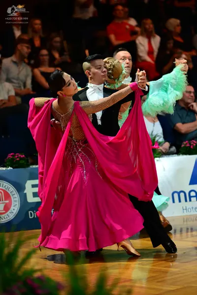 Dancesport competitor: Male dancer: black suit with a white shirt and a white bow tie
