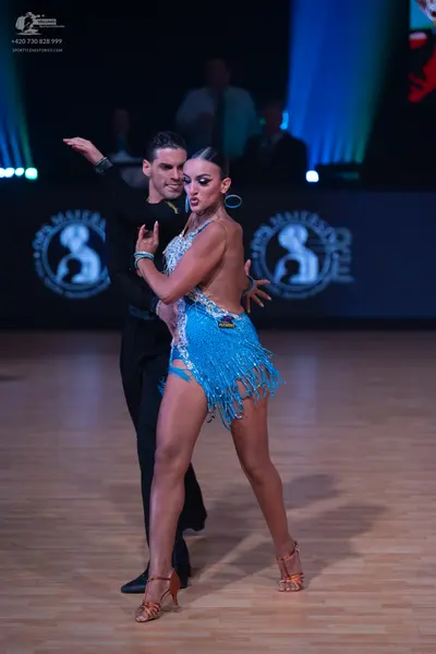 Dancesport competitor: Male dancer: black long-sleeved top and black trousers