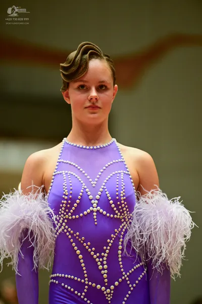 Dancesport competitor: Female**

*   **Color:** Purple
*   **Fabric:** Sequined (appears to be a very f