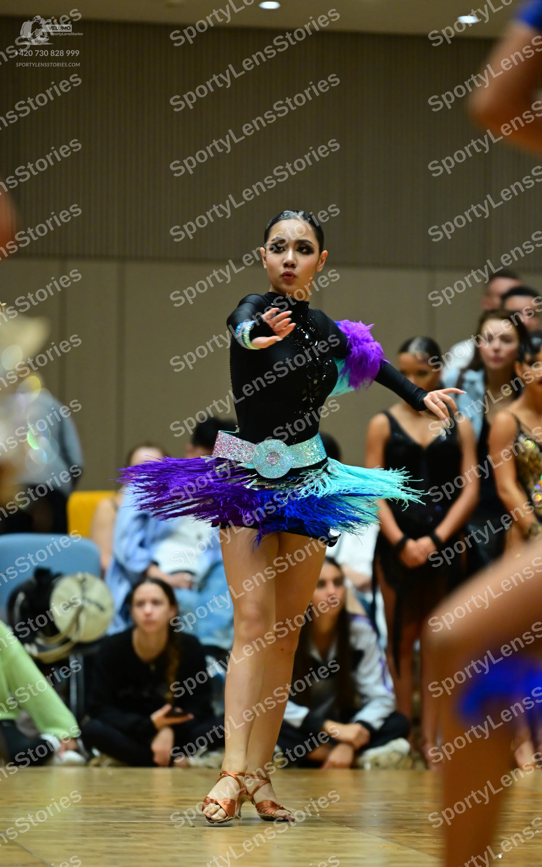 Dancesport competitor: Main female dancer: black long-sleeved latin dress with a sequined light blue be