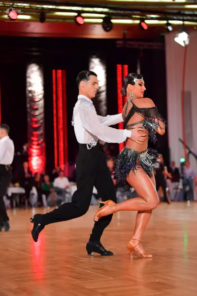 Dancesport competitor: Male dancer: white long-sleeved shirt with silver/white sequin embellishments on