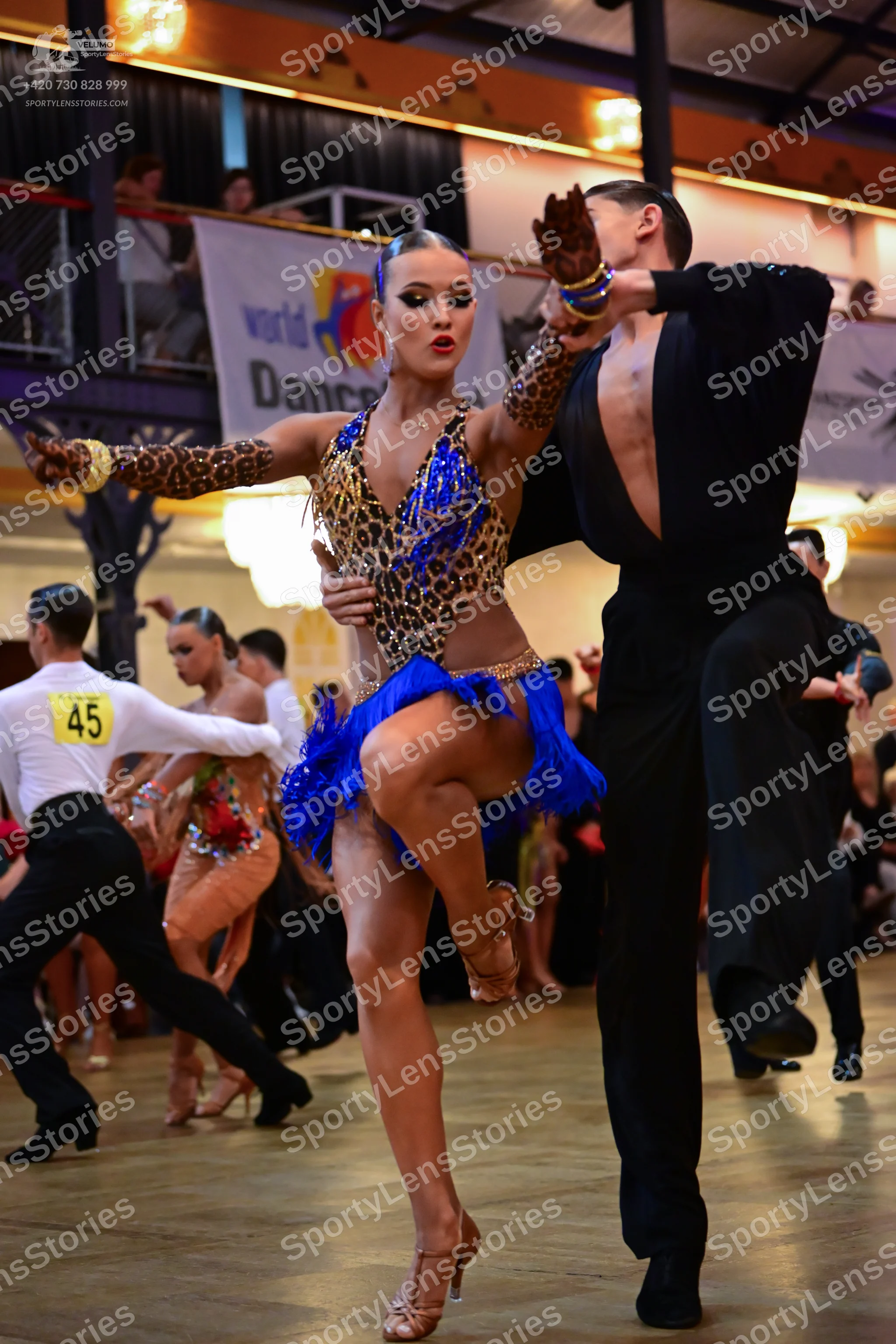 Dancesport competitor #45: Female dancer: leopard print Latin costume with blue sequin bodice, blue fringe
