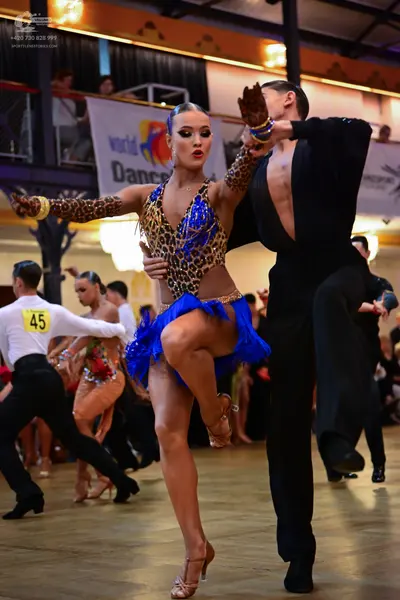 Dancesport competitor #45: Female dancer: leopard print Latin costume with blue sequin bodice, blue fringe 