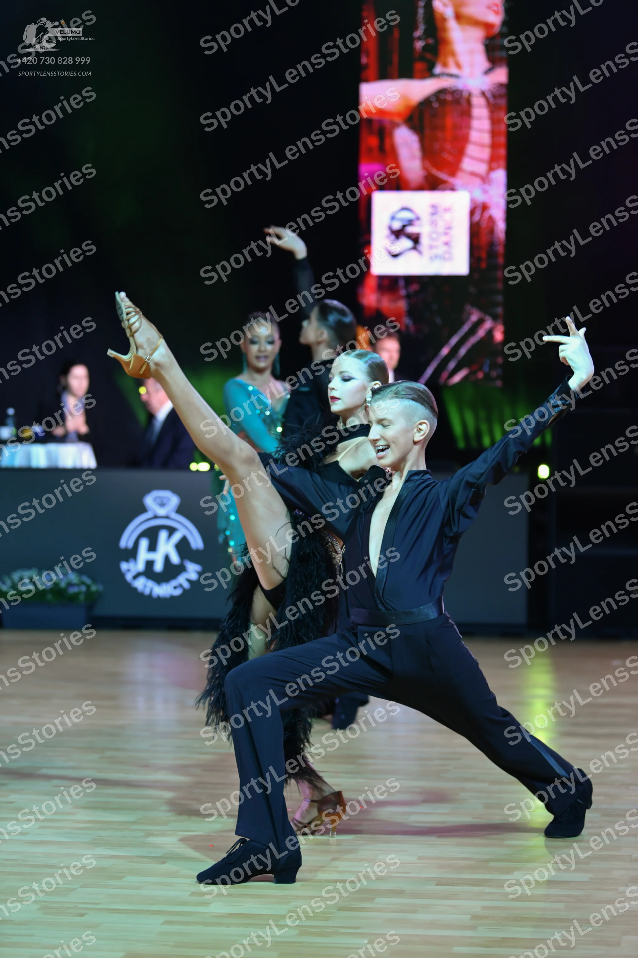Dancesport competitor: Male dancer: black long-sleeved shirt with a deep V-neck and black trousers