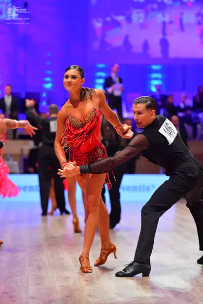 Dancesport competitor: Male dancer: black long-sleeve shirt and black trousers