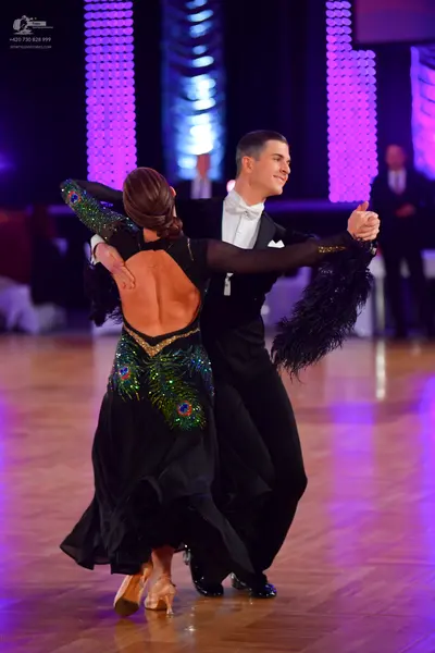 Dancesport competitor: Male dancer: black suit with a white shirt and white bowtie