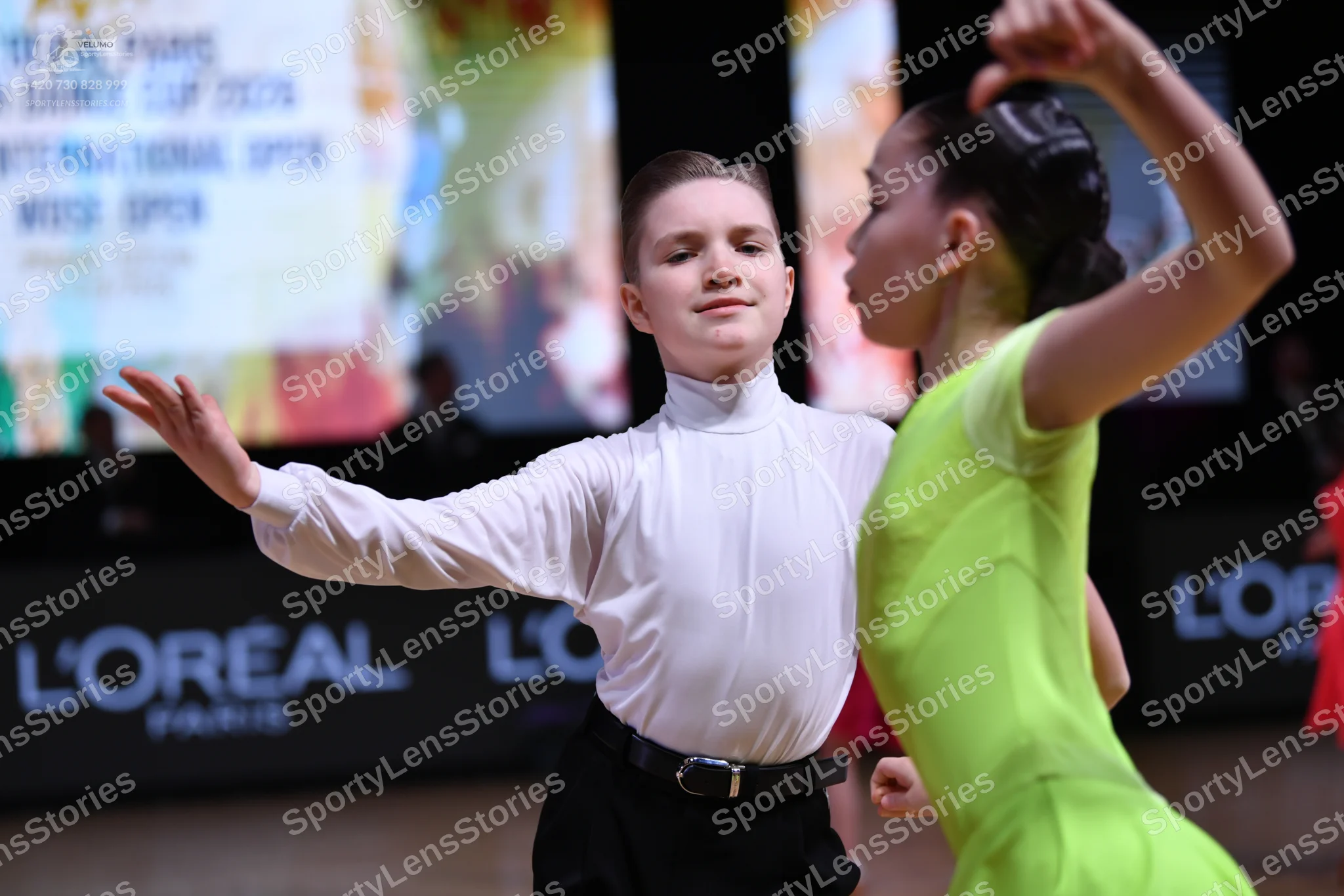 Dancesport competitor: Male dancer: white long-sleeved high-neck shirt and black trousers with a black