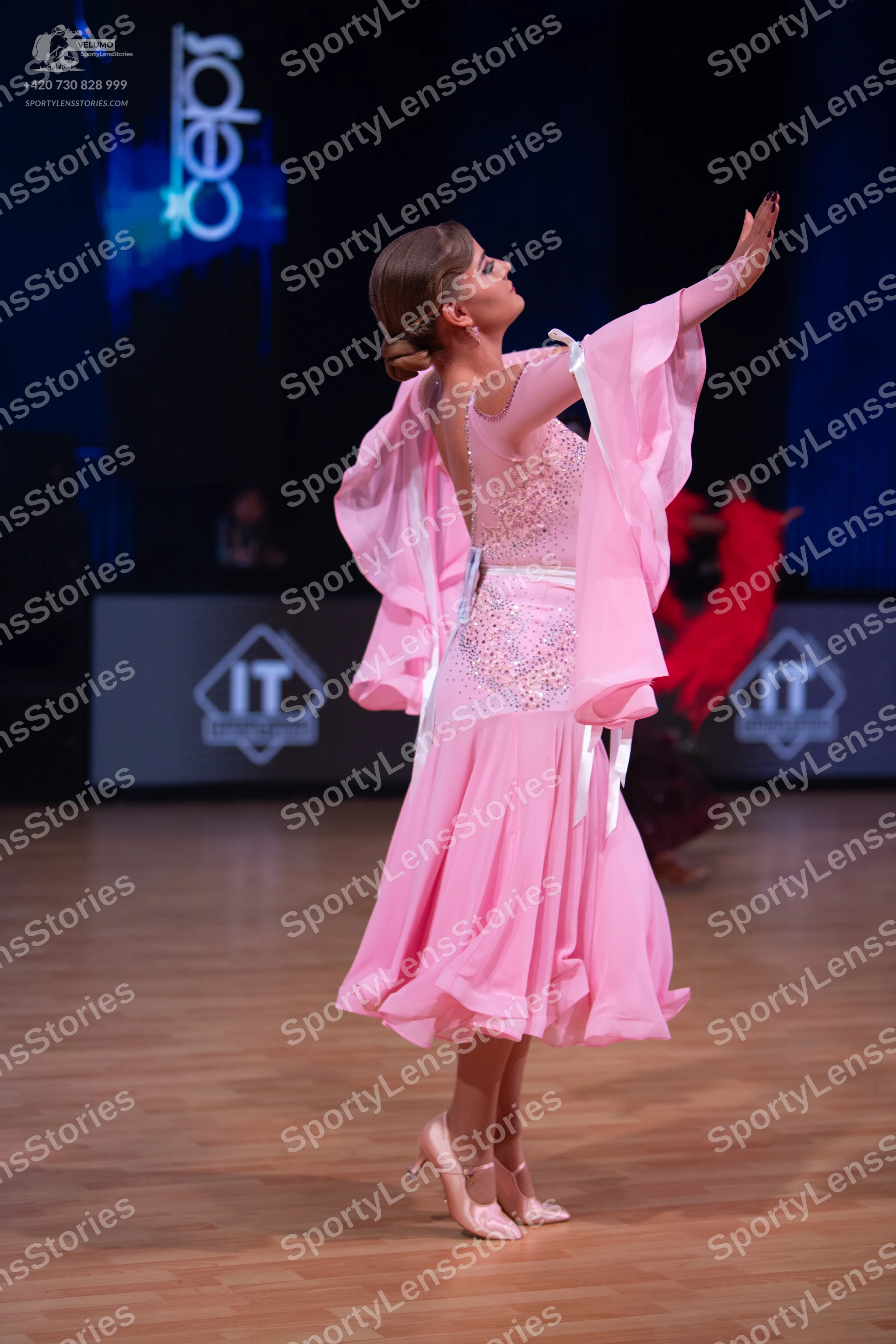 Dancesport competitor: Female dancer: pink ballroom dress with a shimmering, embellished bodice and flo