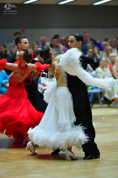 Dancesport competitor: Female dancer 1: red latin dress with ruffles