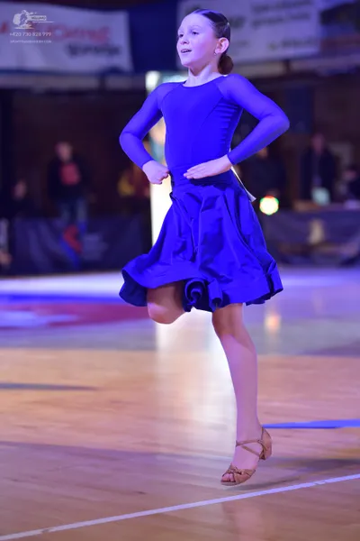 Dancesport competitor: Female dancer: blue long-sleeved dance dress with a flared skirt