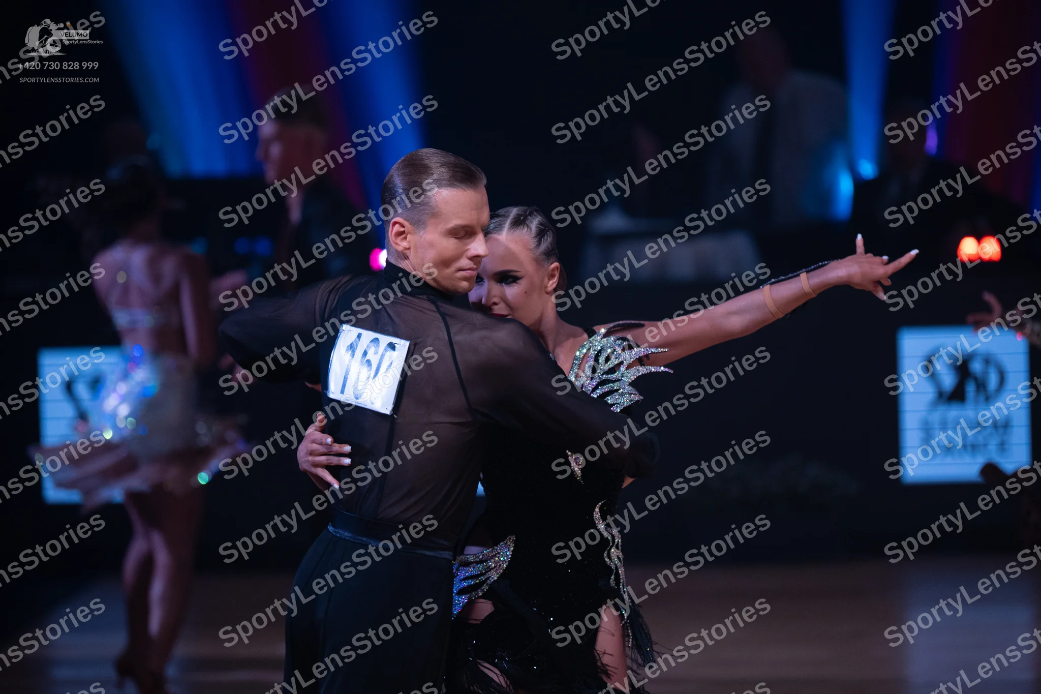 Dancesport competitor: Male dancer: black, long-sleeved, semi-sheer shirt and black trousers