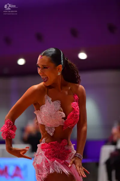Dancesport competitor: Female dancer: pink and white latin dress with floral lace details and fringe