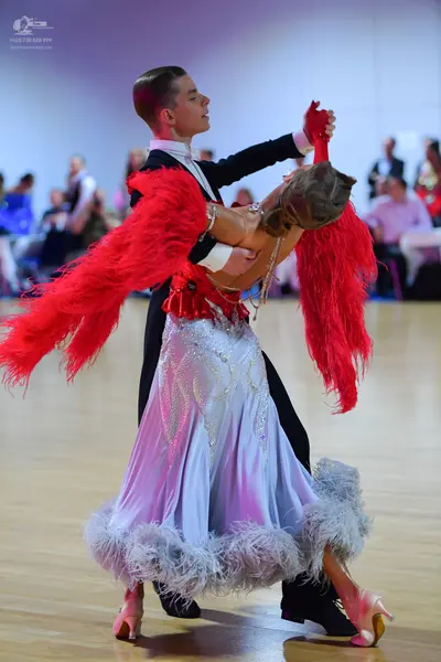 Dancesport competitor: Male dancer: black suit with a white shirt and black bowtie