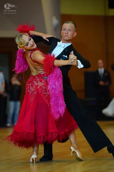 Dancesport competitor: Male dancer: black suit, white shirt, and white bow tie