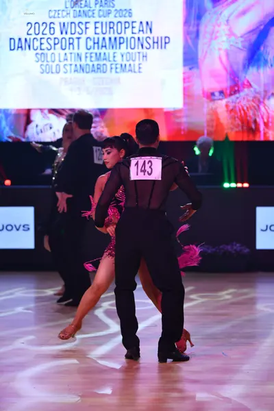 Dancesport competitor: Male dancer: black latin dance top with a sheer mesh back and black trousers