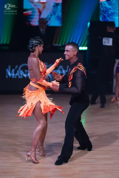 Dancesport competitor: Male dancer: black long-sleeved Latin dance shirt with orange and red flame patt