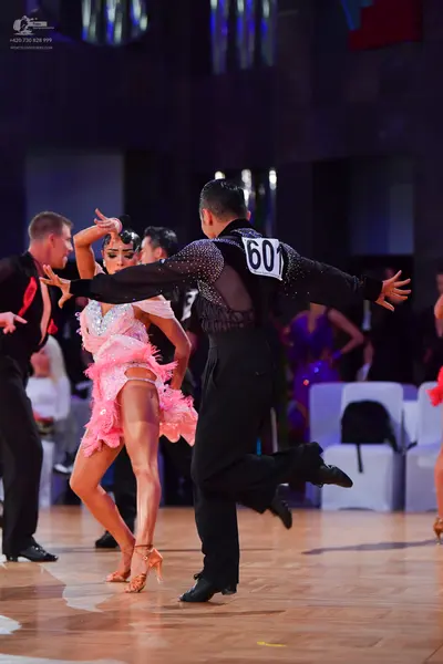 Dancesport competitor #601: Male dancer (left): black long-sleeved shirt and black trousers