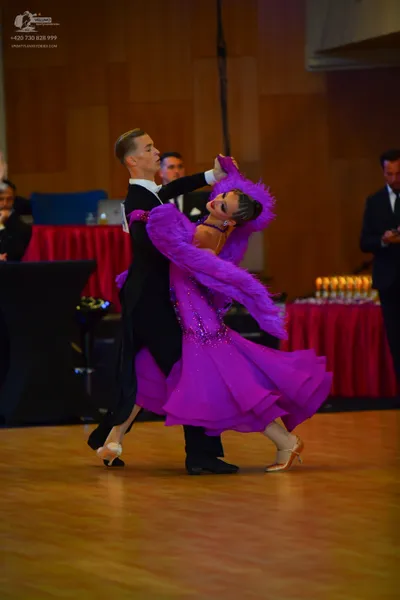 Dancesport competitor: Male dancer: black suit, white shirt, and black bowtie