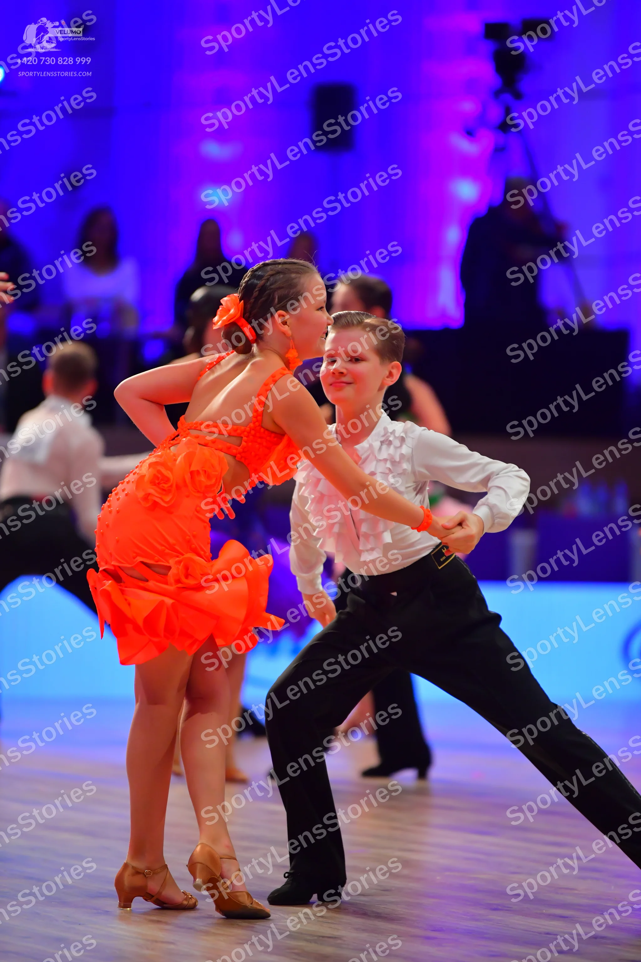 Dancesport competitor: Male dancer: white long-sleeved shirt with ruffles on the chest and cuffs, paire