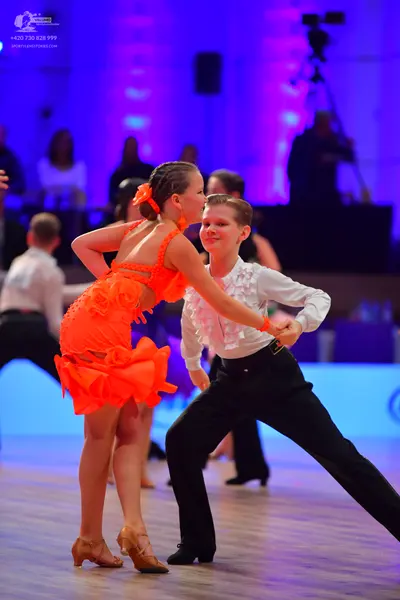 Dancesport competitor: Male dancer: white long-sleeved shirt with ruffles on the chest and cuffs, paire