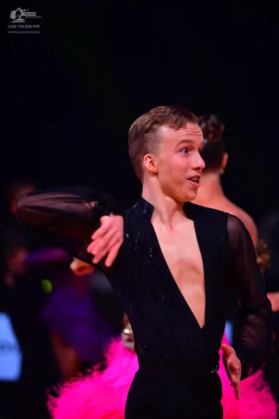 Dancesport competitor: Male dancer: black Latin shirt with a deep V-neckline and sheer sleeves