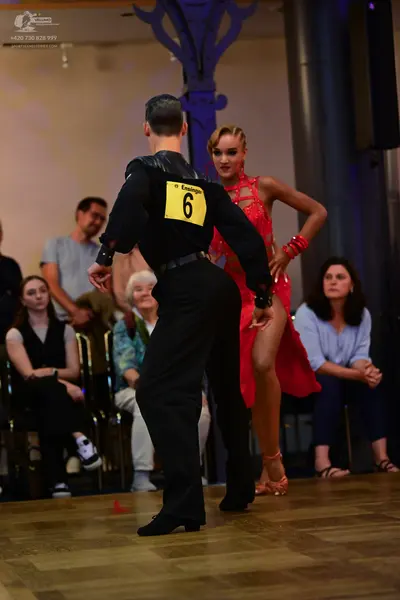 Dancesport competitor: Male dancer: black long-sleeved shirt and black trousers
