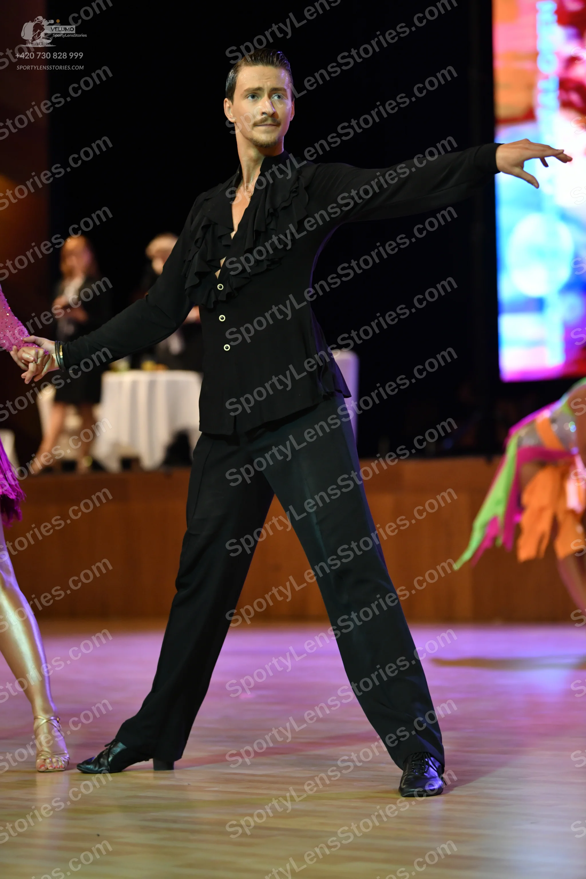 Dancesport competitor: ** Black tailsuit with sequin lapels