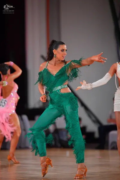 Dancesport competitor #65: Female dancer on the left: pink latin dress with sequins and fringe