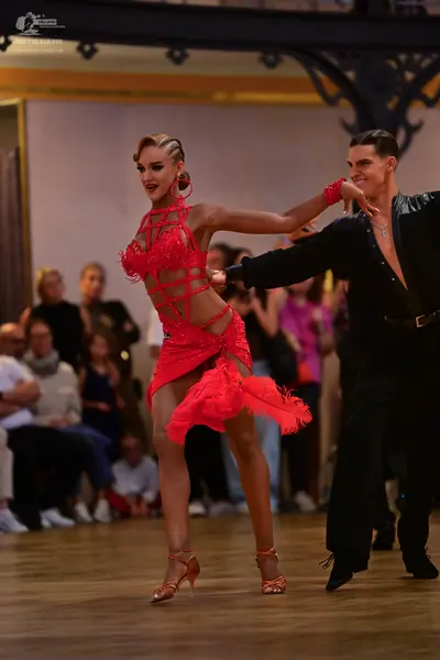 Dancesport competitor: Female dancer: red latin dress with sequins and fringe, and large red hoop earri